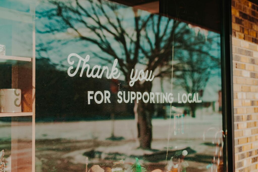 Window sign reading thank you for supporting local, relevant to small businesses seeking local customers