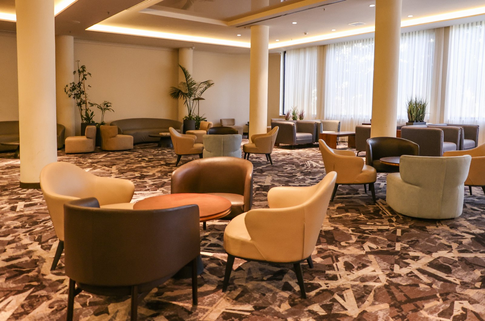 Modern lounge area with comfortable seating and an abstract patterned carpet, typical of a hotel venue